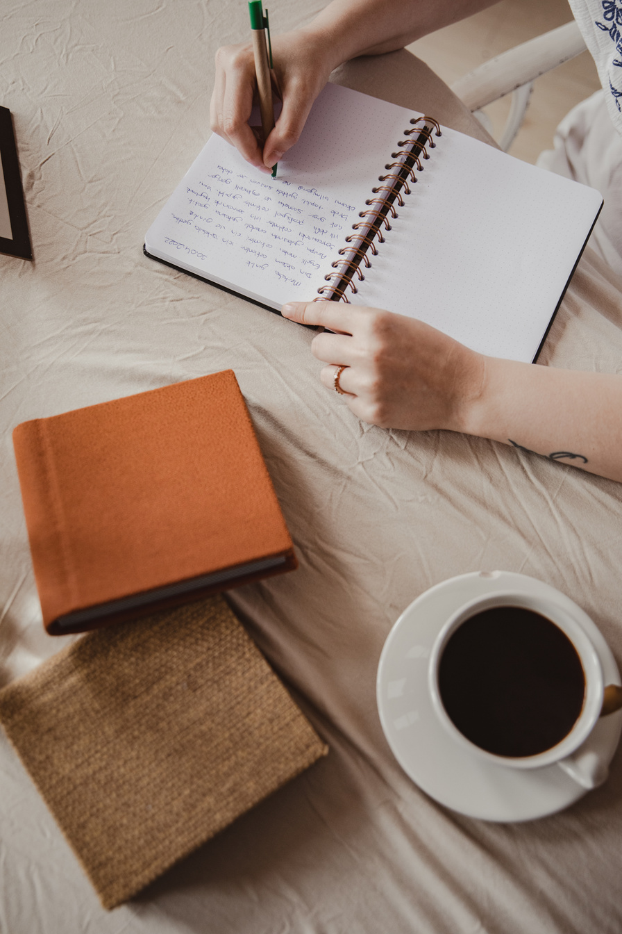 Woman Writing on Notebook